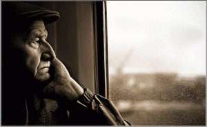 elderly-man-staring-out-window